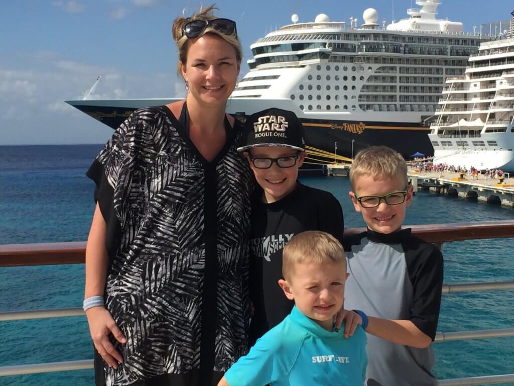 18 Top Secret Disney Fantasy Tips and Tactics  featured by top US family travel blog, Travel with a Plan: image of a family standing at port on Disney Cruise