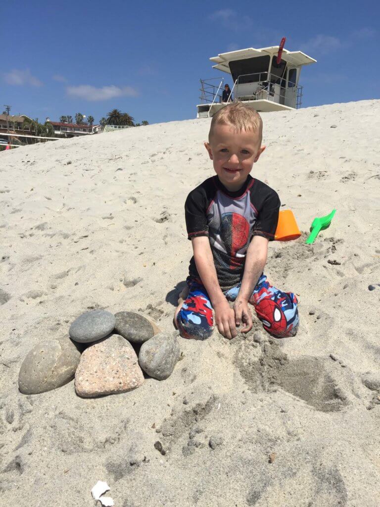 Kids building sandcastles at San Diego beach