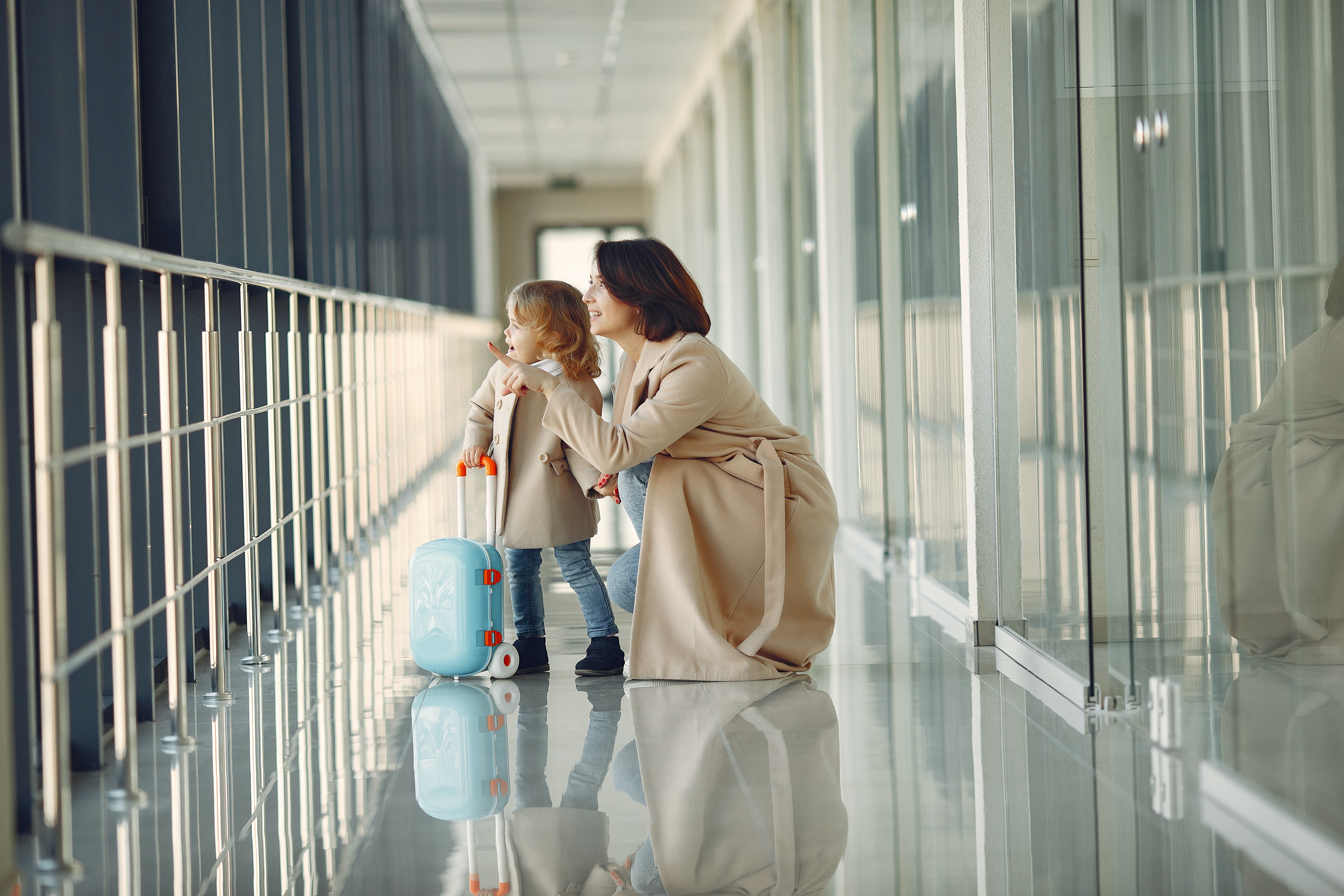 Discover family air travel changes that are here to stay for good!  A mom and her son look out at the friendly skies.  Family Travel tips | Airport Tips | Tips for Flying With Kids