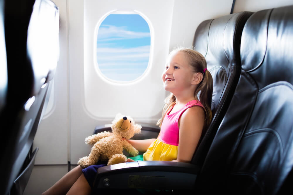 Learn the best tips for flying with kids from top US family travel blog, Travel With A Plan!